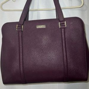 A beautiful plum Michael Kors purse with three sections.